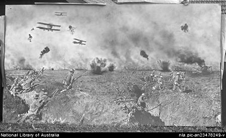 'Very large print of Over the Top, a composite shot of World War I battle in Ypres, signed Frank Hurley 1917, propped against a house' [nla.pic-an23478249]