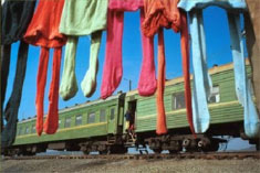 'Children's tights hung out to dry outside stationary railway carriages used to shelter refugees at the Sputnik camp in Ingushetia' [photo by James Hill, from Chechen diary]